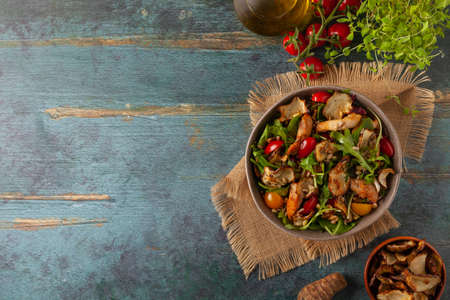 Chicken salad with Jerusalem artichoke crisps. Served in a bowl.の写真素材
