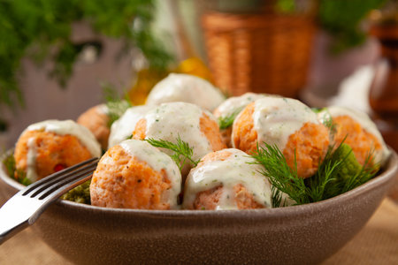Salmon Meatballs with Red Rice. Wooden background.の写真素材