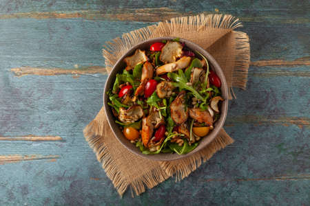 Chicken salad with Jerusalem artichoke crisps. Served in a bowl.の写真素材