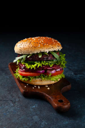 Vegetarian burger. Dark mood. Black background.の写真素材