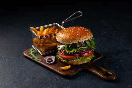 Vegetarian burger. Dark mood. Black background.の写真素材