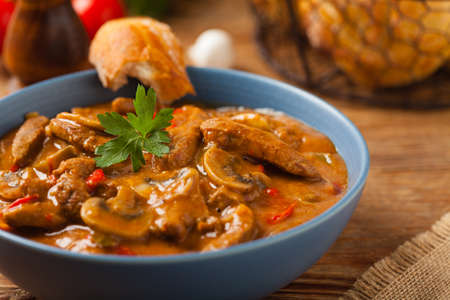 Boeuf, Stroganov, Strogonov. Classic, Russian beef stew. Served in a blue bowl. Front view. Natural background.の写真素材
