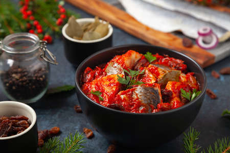 Herring fillet salad in tomato sauce with raisins. Christmas decoration.の写真素材
