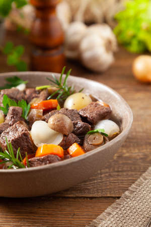 Classic burgundy goulash. Wooden background.の写真素材