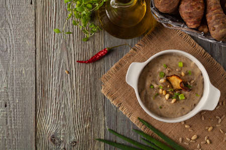 Soup, Jerusalem artichoke cream. Served with croutons in gray bowls. Wooden background.の写真素材