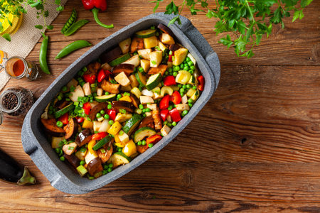 Vegan stew. Prepared in a roasting pan. Natural wooden background.の写真素材