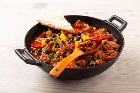 Pork stew with chorizo and black beans. Served with orange and seasoned with hot chili peppers. Perfect with tortillas.の写真素材