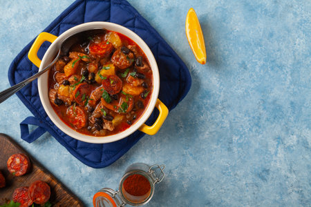 Pork stew with chorizo and black beans. Served with orange and seasoned with hot chili peppers. Perfect with tortillas.の写真素材