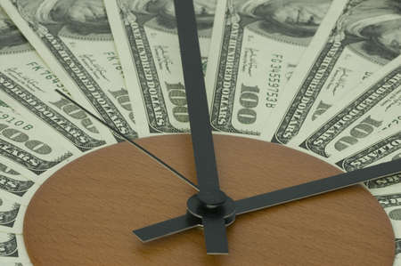 Banknotes lying on a dial and symbolising time spent nothing.