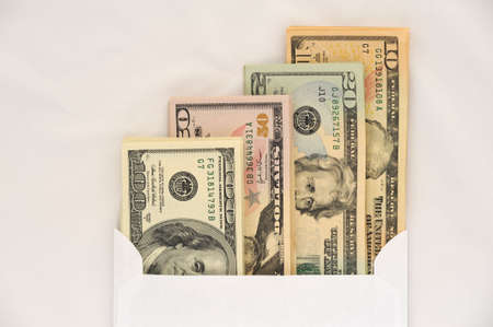 American Dollars in White Envelope on a White Background.の写真素材