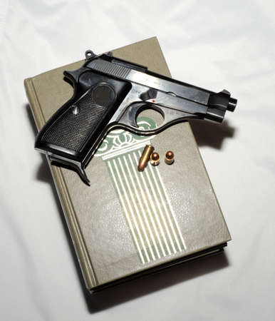 Pistol And Cartridges On  Book. Detective Story.の写真素材