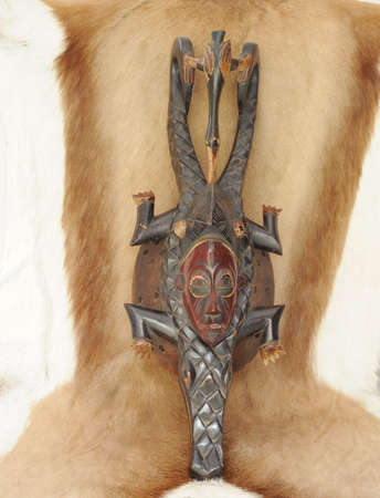  Antique African Mask on a Fur of Wild African Animal.の写真素材