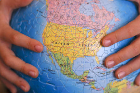 Hands Holding Our Planet  Collected From Small Puzzles.
