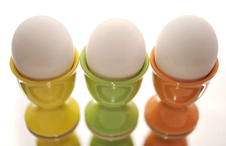 Three Eggs In Eggcups On The Reflecting Surface.の写真素材