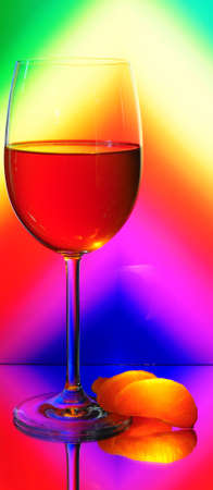  Elegant Tall Wineglass For Red Wine And Segments Of Mandarin  Over Motley  Background.の写真素材