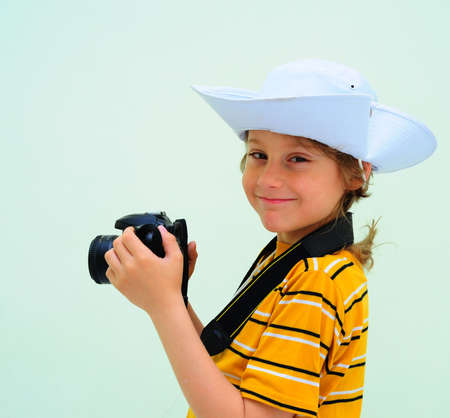 Lovely Young Photographer With Camera Against The Light Green Wall.