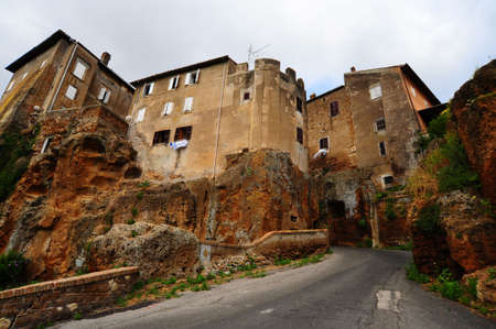 Narrow Asphal Road With Old Buildings In Italian City の写真素材
