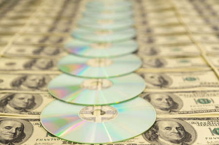 Compact Discs On American Hundred Dollar Bills Backgroundの写真素材