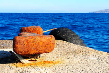 Rusty Bollard on a Concrete Pier of the Island of Rhodes, Greeceの写真素材