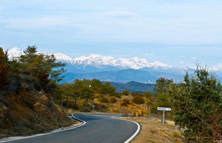 Winding Mountain Road on the Background of Snow-capped Pyreneesの写真素材
