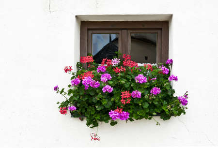 Typical Bavarian Window Decorated With Fresh Flowersの写真素材