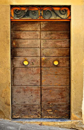 Wooden Ancient Italian Door in Historic Center of Arezzoの写真素材