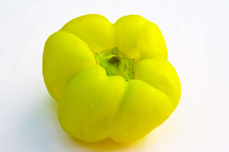 Yellow Pepper Coated with Water Drops on White Background