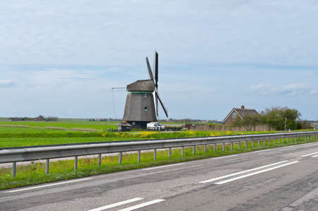 Old Dutch Windmill at the Modern Highwayの写真素材