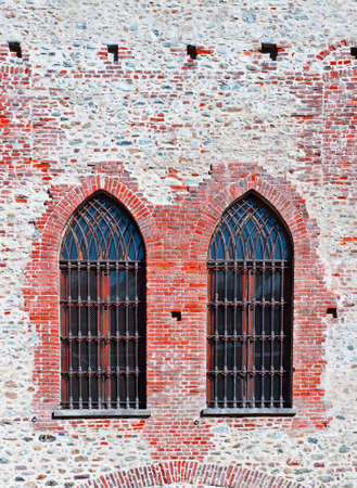 Closed  Gothic Windows on Old Brick Wallの写真素材