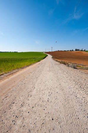 High-voltage Power Line Passes through the Plowed Fields in Israelの写真素材