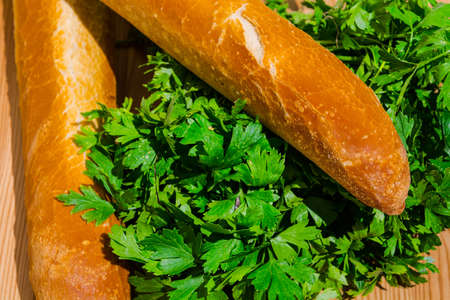Parsley and Baguette on the Cutting Boardの写真素材