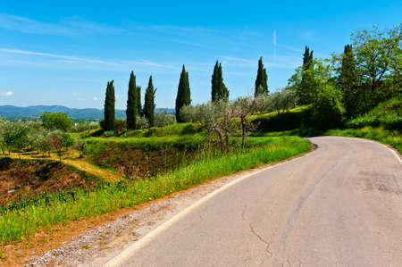 Asphalt Road Leading to the Farmhouse in Umbria, Italyの写真素材