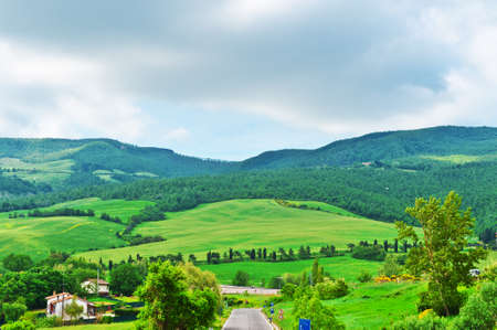 Asphalt Road Leading to the Farmhouse in Umbria, Italyの写真素材