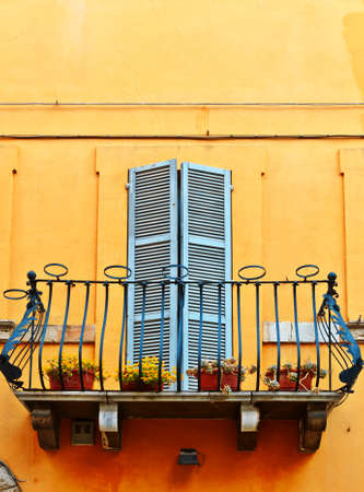 The Renovated Facade of the Old Italian House with Balcony