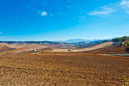 Farmhouse on the Plowed Field in Spainの写真素材