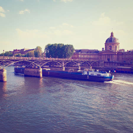 Barge Passes under a Bridge Across the Seine in Parisの写真素材