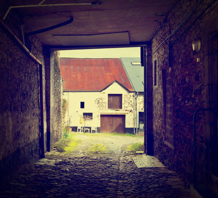 Arched Entrance to the Courtyard in the  Belgian City, Retro Effect の写真素材