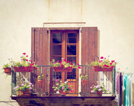 Window with Open Wooden Shutters, Decorated with Fresh Flowers, Retro Effectの写真素材