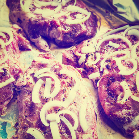 Raw Meat with Pepper and Onion on Foil, Retro Effectの写真素材