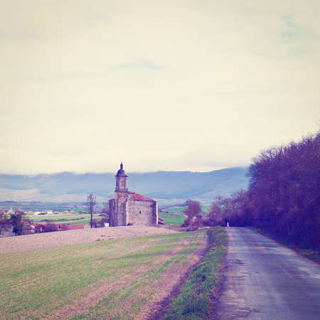 medieval spanish church surrounded by fields in the rainy weatherの写真素材
