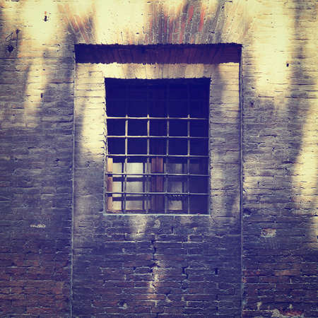 The Barred Window of the Old Jail in Italyの写真素材