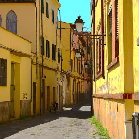 Narrow Alley with Old Buildings in Italian City of Pisaの写真素材