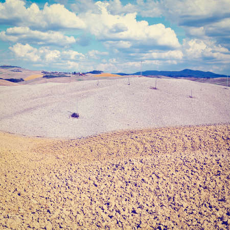 Power Lines on the Plowed Sloping Hills of Tuscany in the Autumn, の写真素材