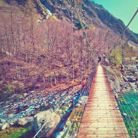 Cable-Stayed Bridge across Mountain Stream in the Italian Alps, Piedmontの写真素材