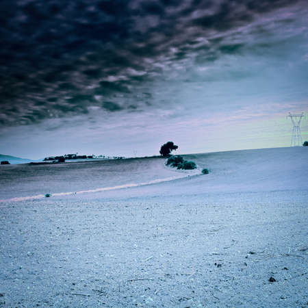 Power Line on the Plowed Field in Spain at Sunset, Vintage Style Toned Picture