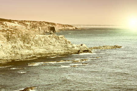 Rocky Coast of Atlantic Ocean in Portugal at Sunset, Vintage Style Toned Pictureの写真素材