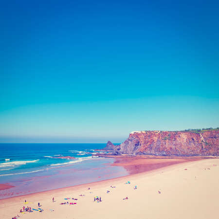 Sandy Beach on the Rocky Coast of Atlantic Ocean in Portugalの写真素材