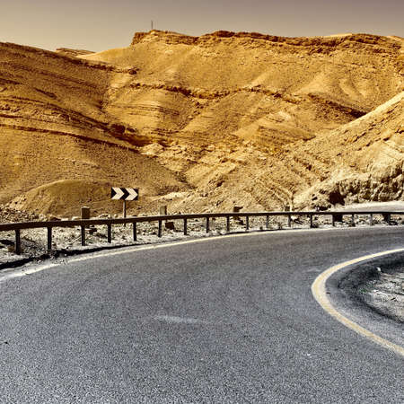Asphalt Road in the Negev Desert in Israel, Vintage Style Toned Pictureの写真素材