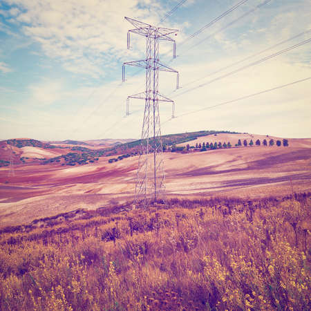 Power Line on the Plowed Field in Spain, Vintage Style Toned Pictureの写真素材