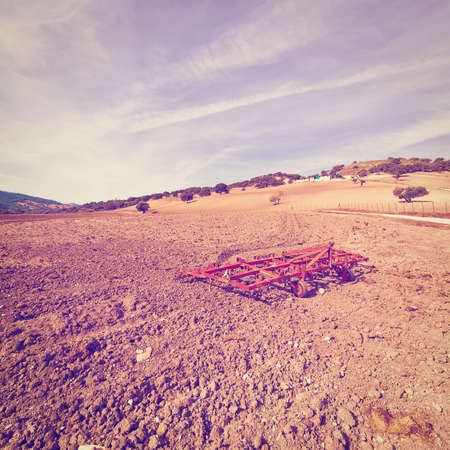Landscape with Harrow on the Plowed Field in Spain, Vintage Style Toned Pictureの写真素材